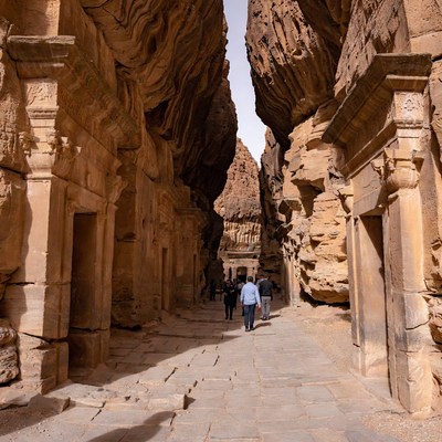 Tourists Walking in Ancient Rock Temple Canyon