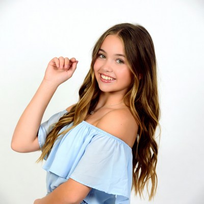 Teen girl smiling in off-shoulder top