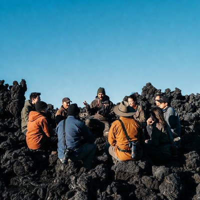 Group hikers meeting on volcanic rocks