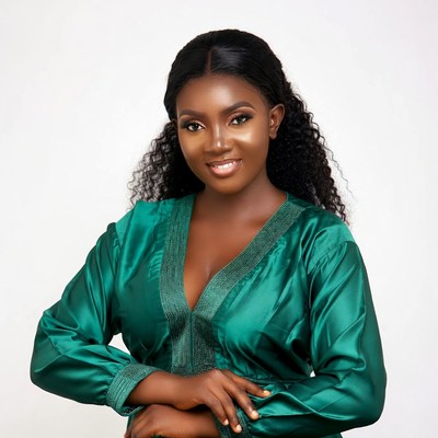 African woman in green dress smiling