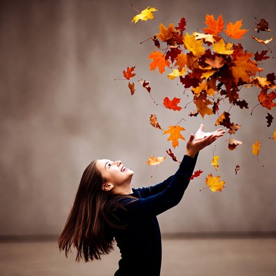 Woman catching falling autumn leaves