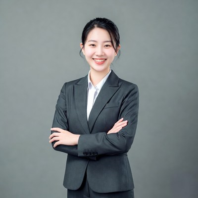 Asian woman in suit with arms crossed