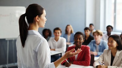 Female teacher lecturing diverse classroom students