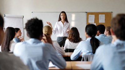 Female teacher presenting to diverse students