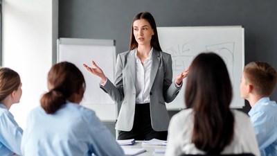 Woman presenting to students in classroom