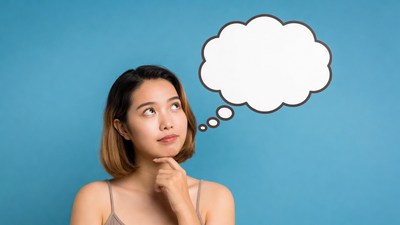 Asian woman thinking with empty speech bubble