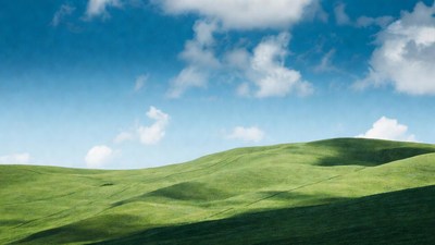 Rolling Green Hills Under Blue Sky
