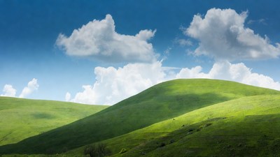 Green Rolling Hills Under Blue Sky