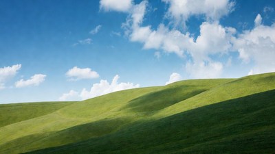 Rolling Green Hills Under Blue Sky