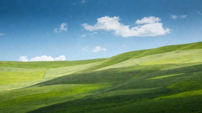 Rolling Green Hills Under Blue Sky