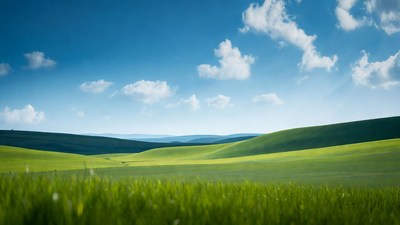 Green rolling hills under blue sky