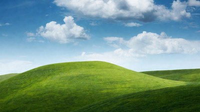Rolling Green Hills Under Blue Sky