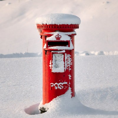Red Post Box Covered in Snow