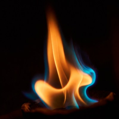Blue flame burning on dark background