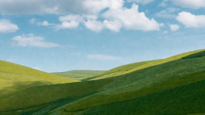 Rolling Green Hills Under Blue Sky