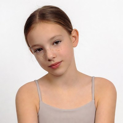 Girl with freckles in gray camisole