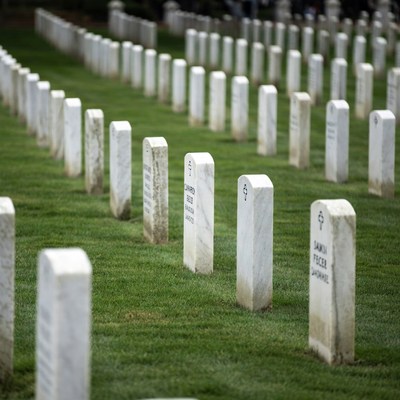 Rows of white gravestones in cemetery