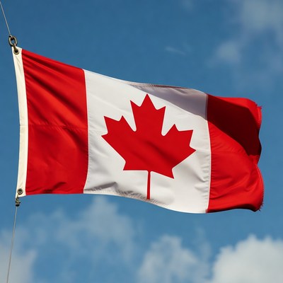 Canadian flag waving in blue sky