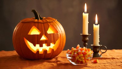 Lit Jack-o-Lantern with Candles and Candy Corn