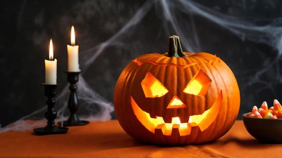 Lit Jack-o-Lantern with Candles and Candy