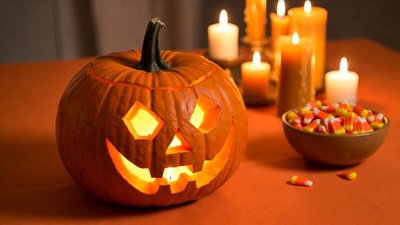 Lit Jack-O-Lantern with Candy and Candles