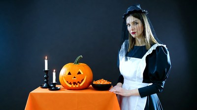 Woman in Witch Maid Costume with Jack-o'-lantern