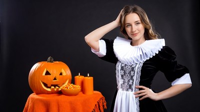 Woman in maid costume with Halloween pumpkin