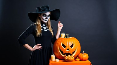 Woman in Skeleton Makeup with Jack-o-Lantern