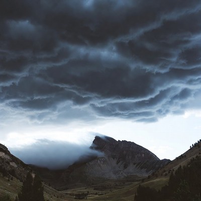 Dramatic Storm Clouds Over Mountain Valley