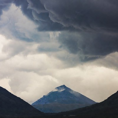Mountain Peak Under Dark Storm Clouds
