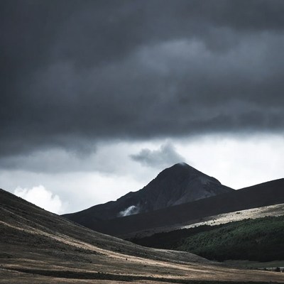Volcano under stormy clouds