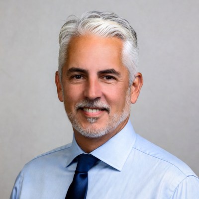 Smiling man with silver hair and mustache