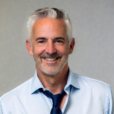 Smiling senior man in blue shirt