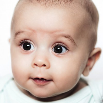 Baby with big eyes smiling