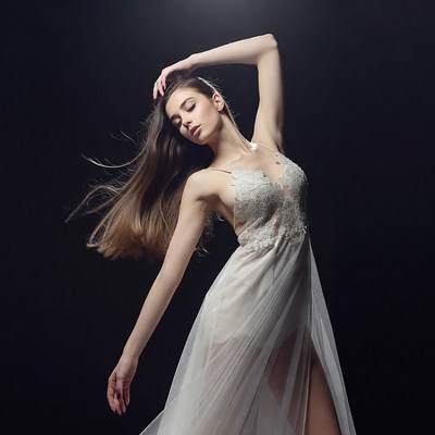 Woman posing in flowing white dress