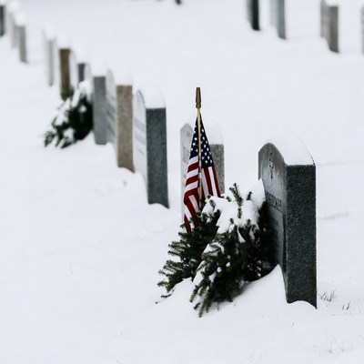 Snowy Cemetery with American Flags