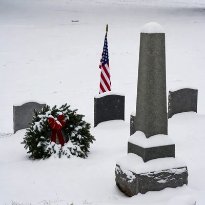 Snowy Cemetery with American Flag and Wreath