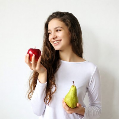 Girl holding apple and pear