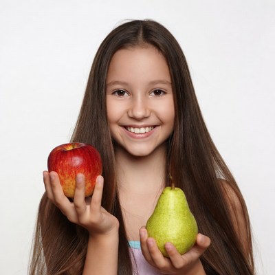 Girl holding red apple and green pear