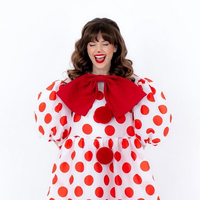 Woman in red polka dot clown costume