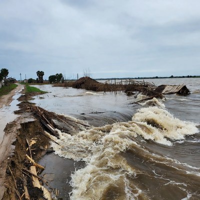 Flooded road with debris and waves