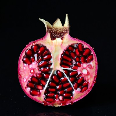 Split Open Pomegranate on Black Background
