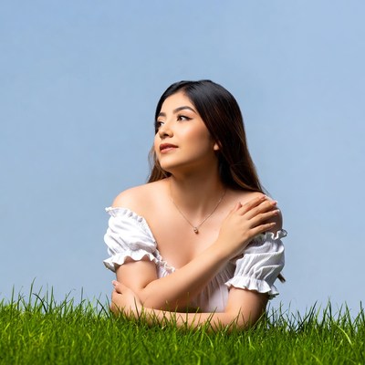 Asian woman lying on grass