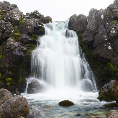 Waterfall cascading between rocky cliffs