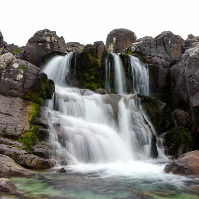 Waterfall cascading over mossy rocks