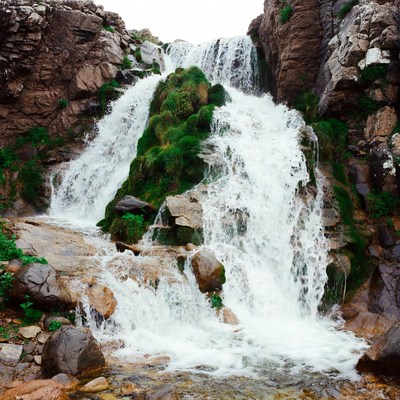Waterfall cascading between rocky cliffs
