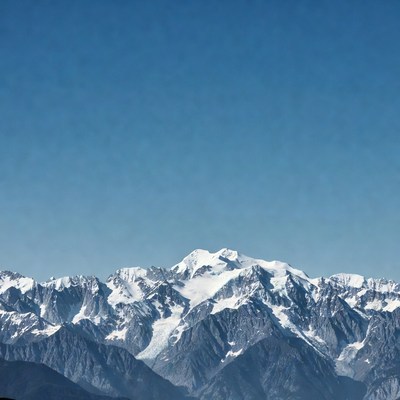 Snowy Mountain Peaks Under Blue Sky