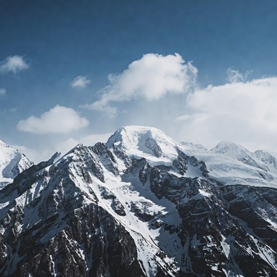 Snowy Mountain Peaks Under Blue Sky
