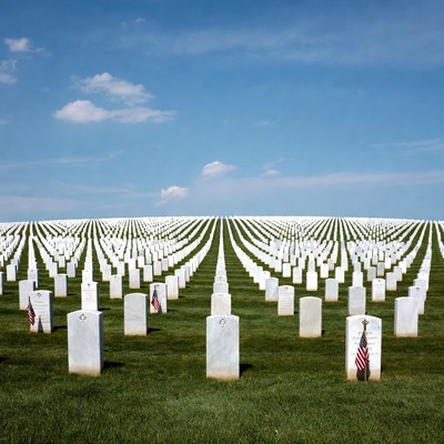 Rows of White Headstones with American Flags