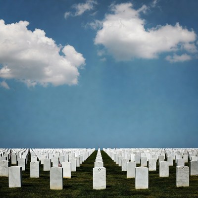 Rows of White Headstones in Cemetery